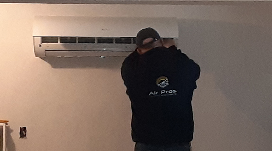 man installing ductless ac unit on wall hyannis ma